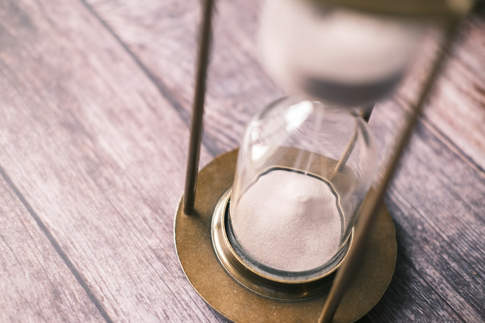 an hourglass sitting on top of a wooden table