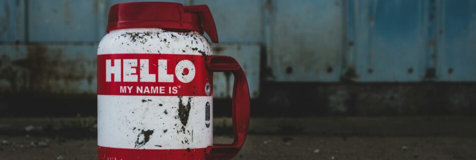 selective focus photography of white and red Hello printed bottle
